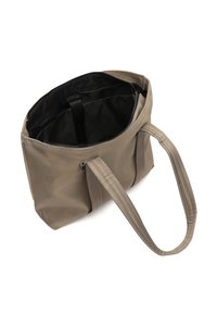Sac fourre-tout beige avec longues poignées, fermeture éclair en haut, doublure intérieure noire et sangle intérieure.