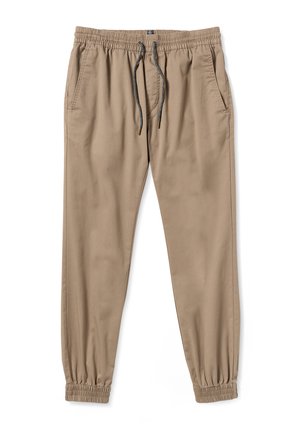 Beige joggingbroek gemaakt van lichtgewicht materiaal, met een elastische tailleband met trekkoord, zijzakken en elastische boorden.