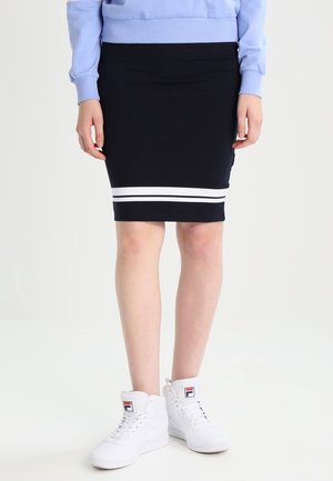 Personne portant une jupe noire avec deux bandes blanches près de l'ourlet, un sweat-shirt bleu clair et des baskets montantes blanches avec un logo.