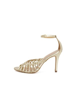 Sandalo dorato con tacco alto, punta aperta, fascia intrecciata frontale e cinturino alla caviglia con fibbia su sfondo bianco.