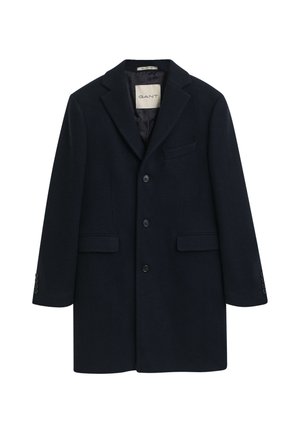 Wollmischung Mantel in Marineblau mit Reverskragen, zwei Fronttaschen, Drei-Knopf-Verschluss und knöpfbaren Manschetten. Etikett innen sichtbar.
