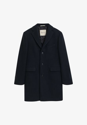 Marineblauwe wolmix jas met notched revers, twee voorkruiszakken, drukknoopsluiting en knoopmanchetten. Etiket zichtbaar aan de binnenkant.