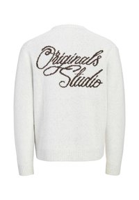 Pull en maille blanc avec « "Originals Studio" » écrit en grosses lettres marron au dos. Manches longues, poignets et ourlet côtelés.