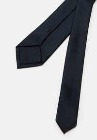 Marineblå silkebind med en jevn tekstur, avsmalnet form og spiss ende. Har et klassisk design som passer til formelle anledninger.