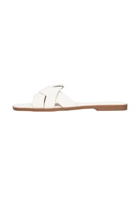 Sandalia plana blanca con correas entrecruzadas. Fabricada en suave cuero sintético, presenta una suela plana con un acento marrón claro. Diseño sencillo.