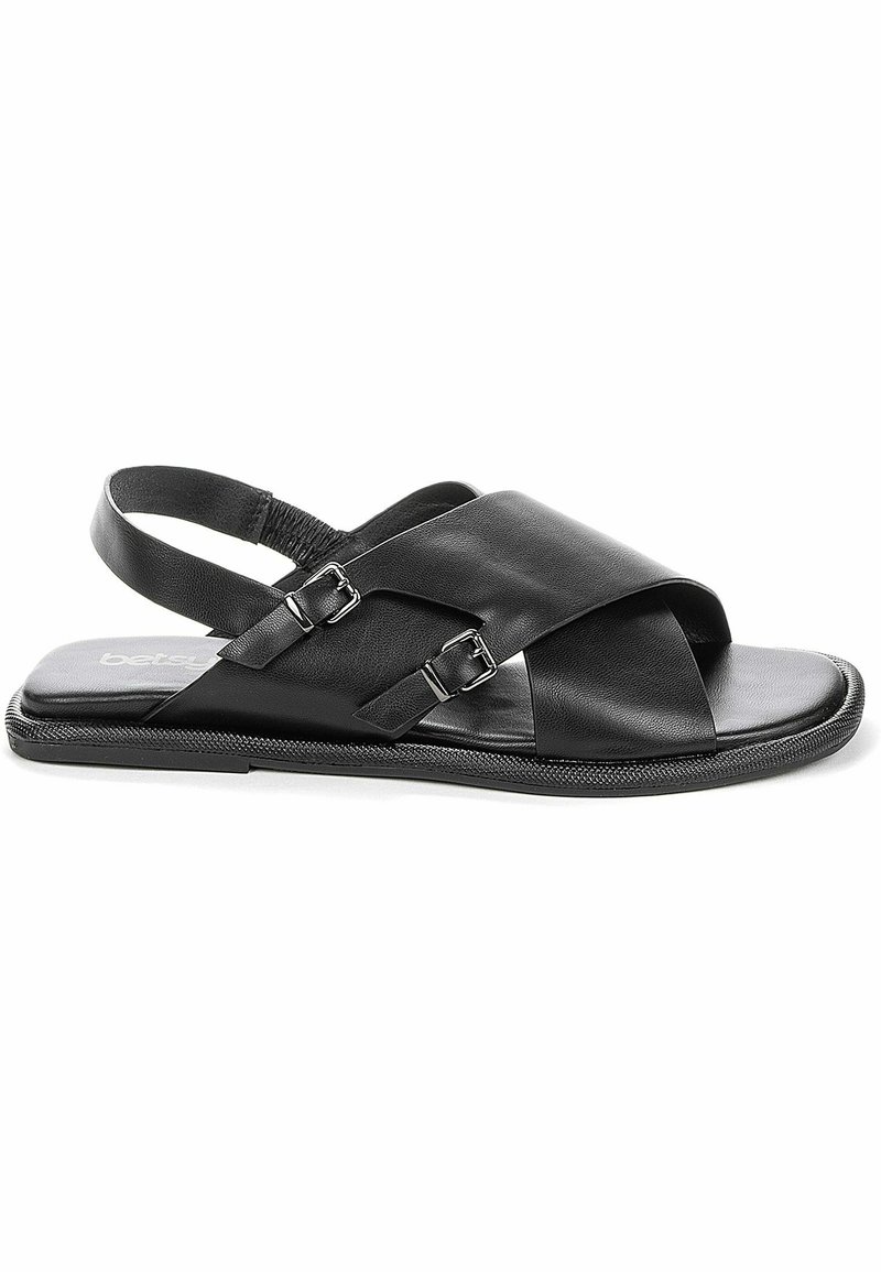 Sandales en cuir noir avec un design de lanière croisée, deux boucles réglables, une semelle rembourrée et un pourtour texturé.