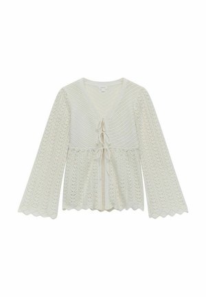 Strickbluse in Creme mit V-Ausschnitt, langen Glockenärmeln, gewelltem Saum und einer vorderen Bindeschleife. Verfügt über filigrane Spitzenmuster im gesamten Design.