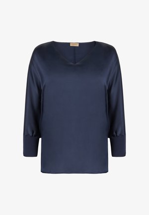 Blouse en satin bleu marine avec manches trois-quarts, encolure en V et larges poignets côtelés.