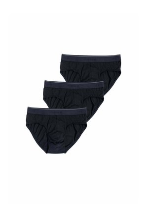 Tre slip neri da uomo con elastici in vita disposti in una linea diagonale discendente su sfondo bianco.