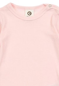 Light pink ribbed long-sleeve top with a round neckline and snap fastener at the shoulder, featuring a soft, textured fabric.