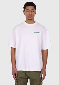 Hvid bomulds t-shirt med korte ærmer og rund halsudskæring; 'DROPSIZE' logo i grøn og gul på venstre side. Glat tekstur.