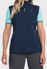 Námořnická modrá bezrukávová vesta s vysokým límcem, předním zipem a dvěma bočními kapsami. Vyznačuje se hladkou texturou a minimalistickým designem.