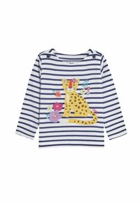 Bela in mornarsko modra črtasta srajca z dolgimi rokavi, ki prikazuje rumeno leopardjo ilustracijo, obkroženo s pisanimi cvetovi. Pletenina z okroglim izrezom.