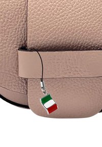 Beige textuur tas hoek met een kleine hanger in de kleuren van de Italiaanse vlag: groen, wit en rood in verticale strepen.