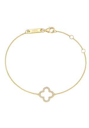 Delicate gold chain bracelet with a small clover-shaped charm encrusted with clear stones and a clasp engraved with Giorgio Martello.