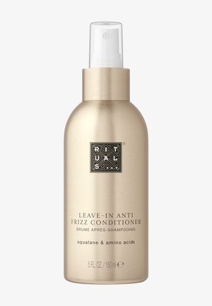 Goldfarbene Aluminiumflasche, 150 ml. Ausgestattet mit einem weißen Sprühkopf. Der Text enthält "Leave-in Anti Frizz Conditioner" und Inhaltsstoffe wie Squalan.