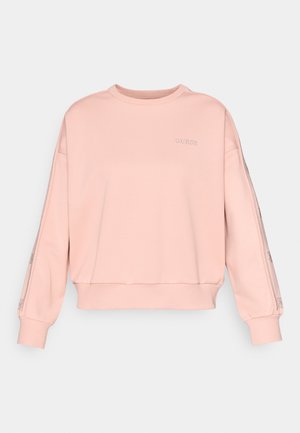 Lys rosa hettegenser med rund hals, senkede skuldre og elastisk midje. Har brodert logo og mønstrede detaljer på ermene.