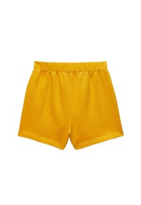 Shorts en coton jaunes avec une taille élastique, de longueur courte et une texture lisse. Présente des bords nets et n'a pas de poches ni de motifs.
