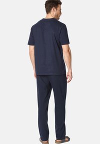 Navy cotton t-shirt and matching pants, relaxed fit, short sleeves, crew neck, with flat seams and no visible logos or patterns.