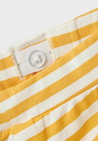 Striped fabric featuring alternating yellow and white colors, with a button and elastic waistband for adjustable fit. Soft texture.