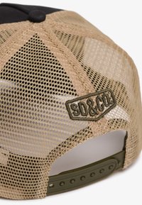 Brun net trucker hat med sort frontpanel; har et grønt broderet "SD&CO" mærke og en justerbar snapback lukning.