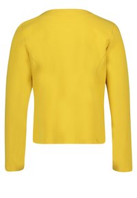 Blazer jaune vif à manches longues en tissu texturé, montré de dos, avec une coupe ajustée et des coutures nettes.