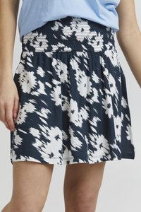 Marineblå nederdel med hvidt blomsterprint, smocket elastisk talje og udsvinget design. Fremstillet af letvægtsstof med blød tekstur.