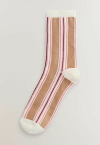 Calzino a righe con tonalità di marrone, rosa e bianco. Texture liscia con polsino a coste. Punta e tallone rinforzati di colore chiaro.