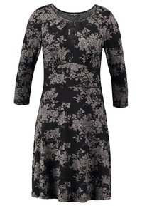 Zwarte jurk met 3/4 mouwen, bloemachtig patroon in grijs, ronde halslijn met een keyhole, aansluitende lijfje en een uitlopende rok. Zachte stoftextuur.