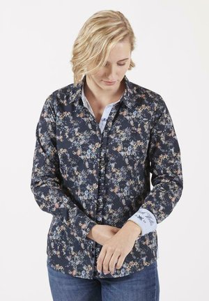 Chemise à boutons sombre avec des motifs floraux, dotée d'un col et d'accents bleu clair. Le design présente de petites fleurs sur un fond marine, avec des détails aux poignets.
