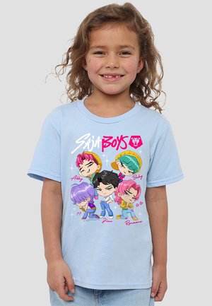 Smiling young child with curly hair wearing light blue T-shirt featuring colorful cartoon characters labeled Abby, Baby, ??, Jinu, and Romance.