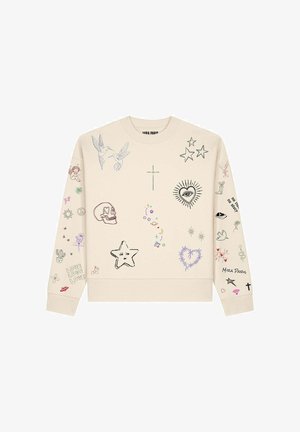 Sweat-shirt beige avec divers dessins colorés, dont des oiseaux, des étoiles, un crâne, un cœur avec un œil, et des symboles sur le devant et les manches.