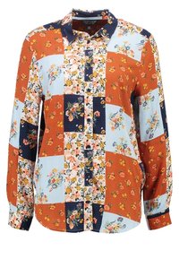 Bloemrijke patchworkshirt met rode, blauwe en marineblauwe panelen. Hemd met knopen en lange mouwen, voorzien van een klassieke kraag. Textuurstof.