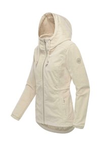 Beige huvad jacka med dragkedja framtill, elastiska ärmslut och rundad fåll. Har två sidfickor och en cirkulär logotyp på ärmen.