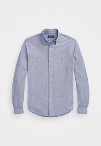 Vaaleansininen nappipaita, jossa klassinen kaulus, pitkät hihat ja rintataskussa kirjailtu logo. Pehmeä tekstuuri.