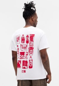 White cotton t-shirt featuring a red graphic print of various food and drink items on the back, along with Chinese characters at the bottom.