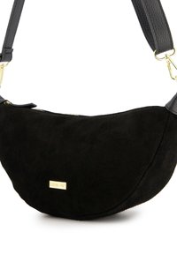 Black suede handbag with a half-moon shape. Features a smooth leather shoulder strap and a gold hardware logo detail. Zipper closure at top.
