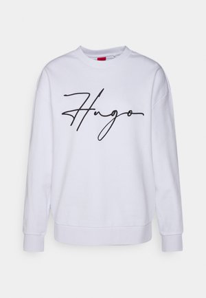 Sweat-shirt blanc à manches longues et col rond, avec un logo "Hugo" en style signature noire centré sur le devant.