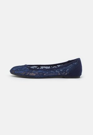 Navy blue ballet flats with lace overlay and soft fabric detailing. Rounded toe and flat sole for comfort. Subtle floral pattern in lace.