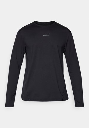 Black long-sleeve T-shirt with a round neck, made of smooth fabric. Features subtle stitching and a small logo on the chest.