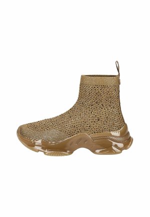 Bottine en tricot brun avec une surface texturée, un bord élastique et une semelle en caoutchouc brillant présentant des découpes sur le côté.