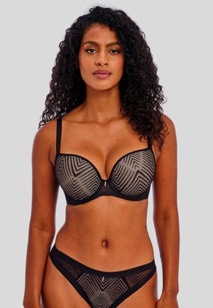 Zwart en beige lingerieset met een semi-transparante bh met een chevronpatroon, onderbroken ondersteuning en bijpassende slips met dunne bandjes.