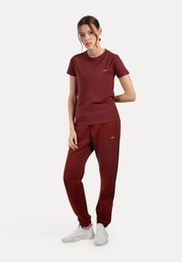 Bordeaux matchende t-shirt og joggers sæt, stof af bomuldsblanding, korte ærmer, elastisk talje, med diskrete logo detaljer.