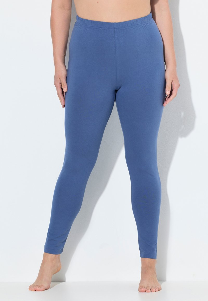 Leggings elasticizzati blu con una texture morbida, vita elasticizzata e design aderente. Nessun motivo o dettagli hardware visibili.