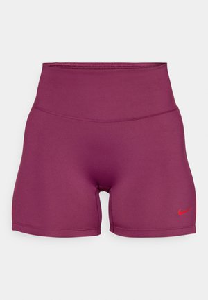 Augstas jostas bikses dziļi bordo audumā ar gludu tekstūru. Pamanāms sarkans Nike logs kreisajā kājā.