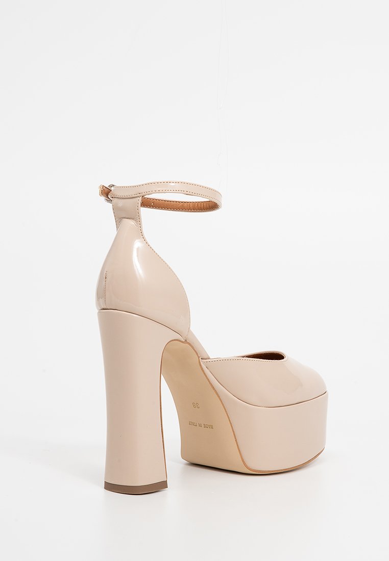 Beige lackleder High Heels mit Plateau und Knöchelriemen, runder Spitze und dickem Blockabsatz. Glatte Textur und glänzendes Finish.