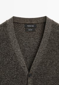 Dark brown cotton cardigan featuring a deep V-neck, fine texture, and a single button closure at the front. Labels visible inside.