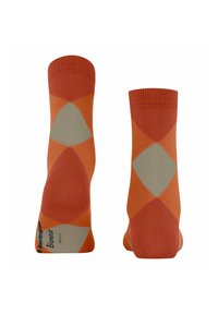 Chaussettes orange ornées d'un motif géométrique en losange dans des nuances variées d'orange et de beige, avec des poignets côtelés et des talons renforcés.