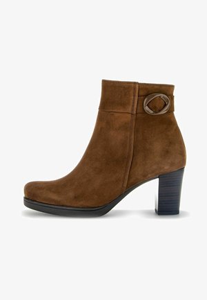 Brown suede ankle boot with a rounded toe, a side buckle accent, and a chunky black heel. Smooth texture with subtle stitching details.