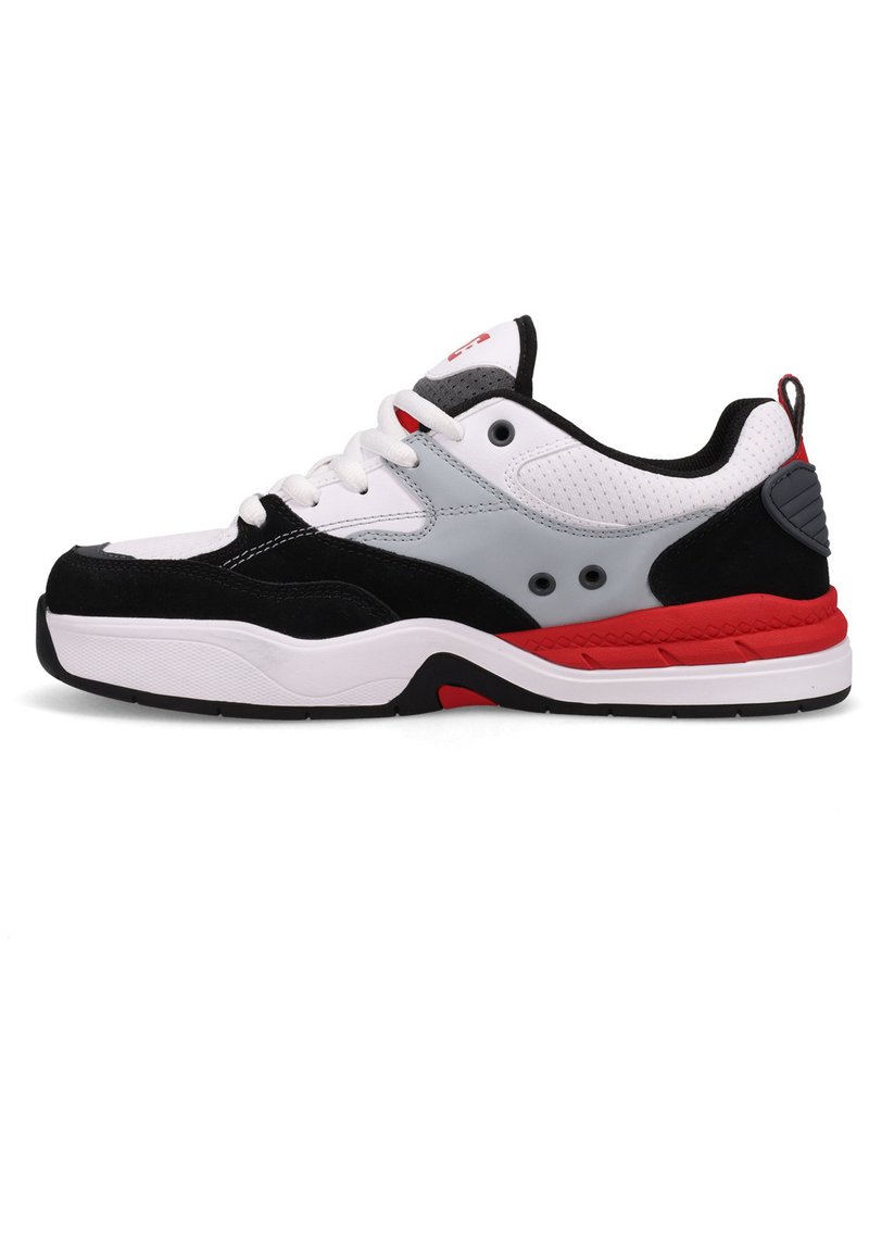 Black, white, and red athletic shoe with suede and synthetic materials. Features a padded collar, rubber sole, and visible ventilation holes.